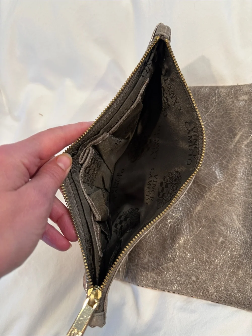 Leather Zip reversible clutch in Metallic taupe and reverses to rose gold